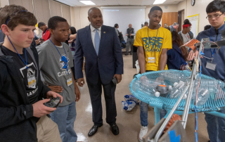 Students demonstrating robotics projects during competition